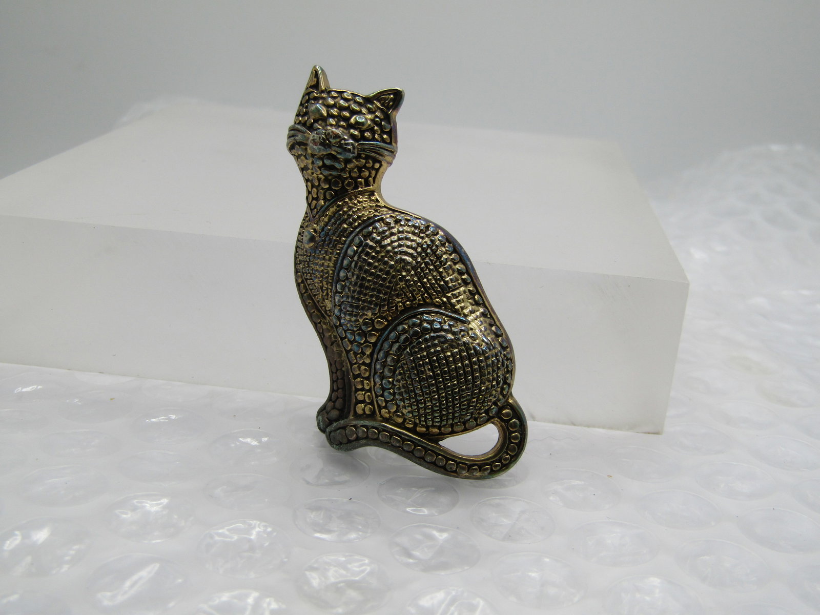 Vintage Two-Tone Gingham Cat Brooch, 1980's-1990's: Vintage Two-Tone Gingham Cat Brooch, 1980's-1990's. The pin is gold tone and silver tone with square and round textured designs throughout the cat similar to a gingham cat or even an Egyptian style.