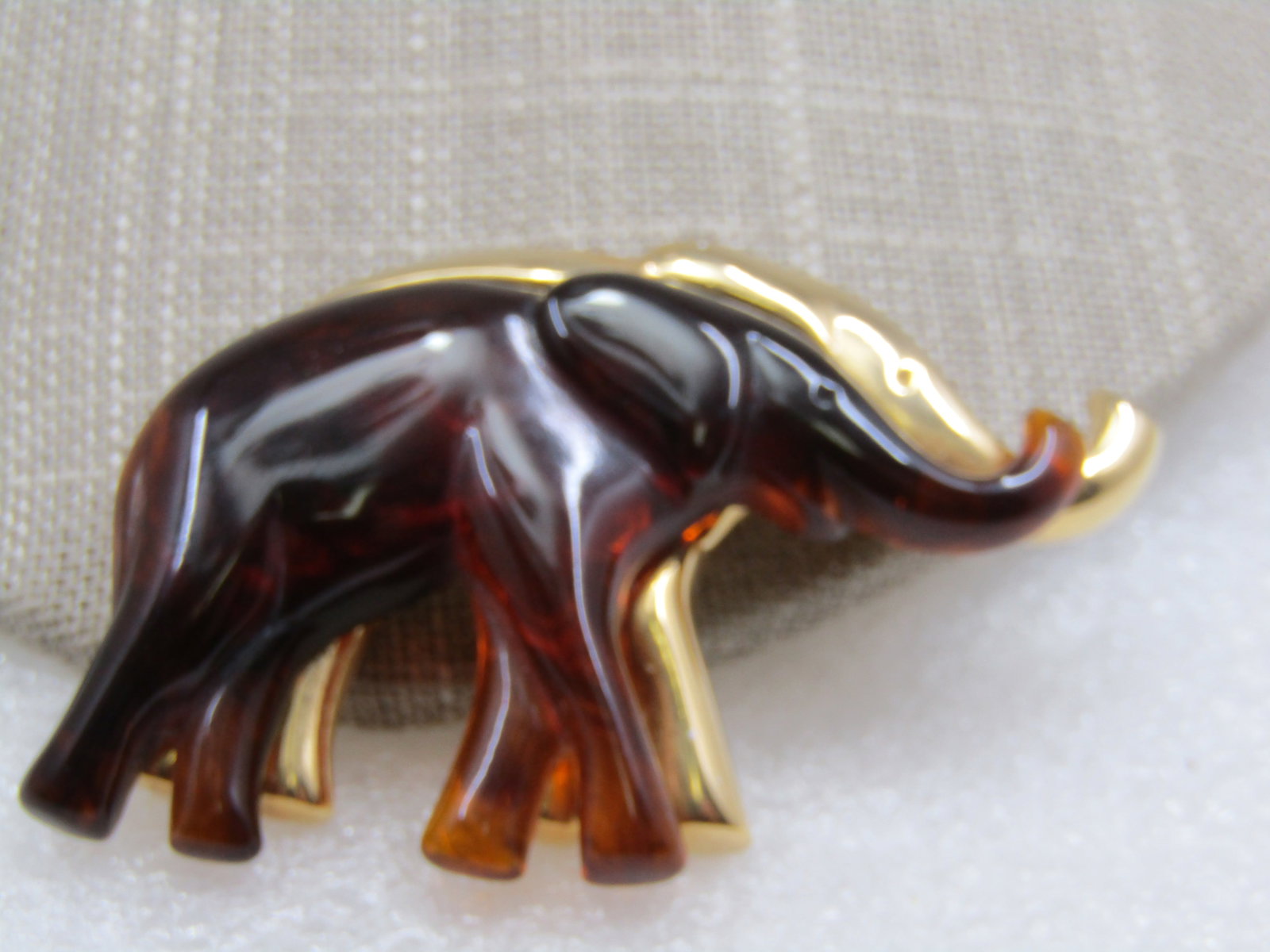 Vintage Liz Claiborne Elephant Brooch, 2.5" by 1.5": Vintage Liz Claiborne Elephant Brooch, 2.5" by 1.5", 1980's-1990's. Ambleer plsatic elephant over a larger gold tone elephant. Smooth finish. Signed LC on the back, gold tone. Very good condition.