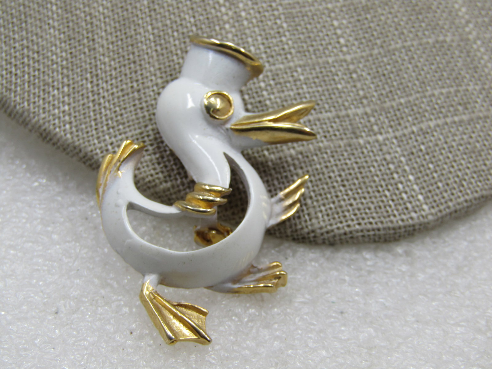 Vintage White Enameled Sailor Duck Brooch, 1960's-1970's: Vintage White Enameled Sailor Duck Brooch, 1960's-1970's, gold tone with white enameling. This has a 3-D look on the front half of the brooch. It is appx. 2" tall and 1.5" wide. It is nto signed.
