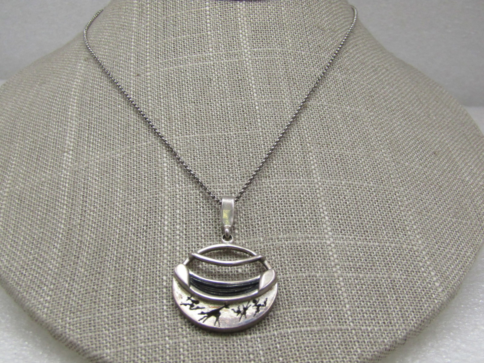 Vintage Sterling African Animal Themed Necklace 18": Vintage Sterling African Animal Themed Necklace 18". This is a round pendant with an open top and curved silver bar across the open circle with a curved raised accent with inlaid shell or horn and