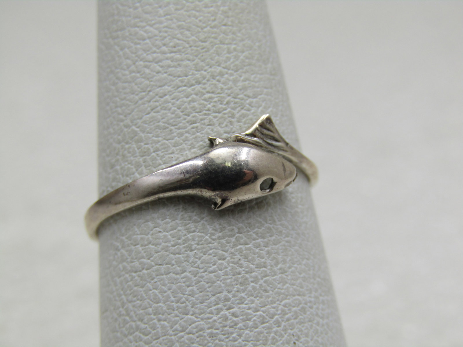 Sterling Silver Dolphin Bypass Ring, Sz. 6.5: Sterling Silver Dolphin Bypass Ring, Sz. 6.5 and appx. .90 grams. Marked sterling and tested. The ring is appx. 6.5mm at top where the tail and the head meet. The ring tapers to appx. 1.8mm at the