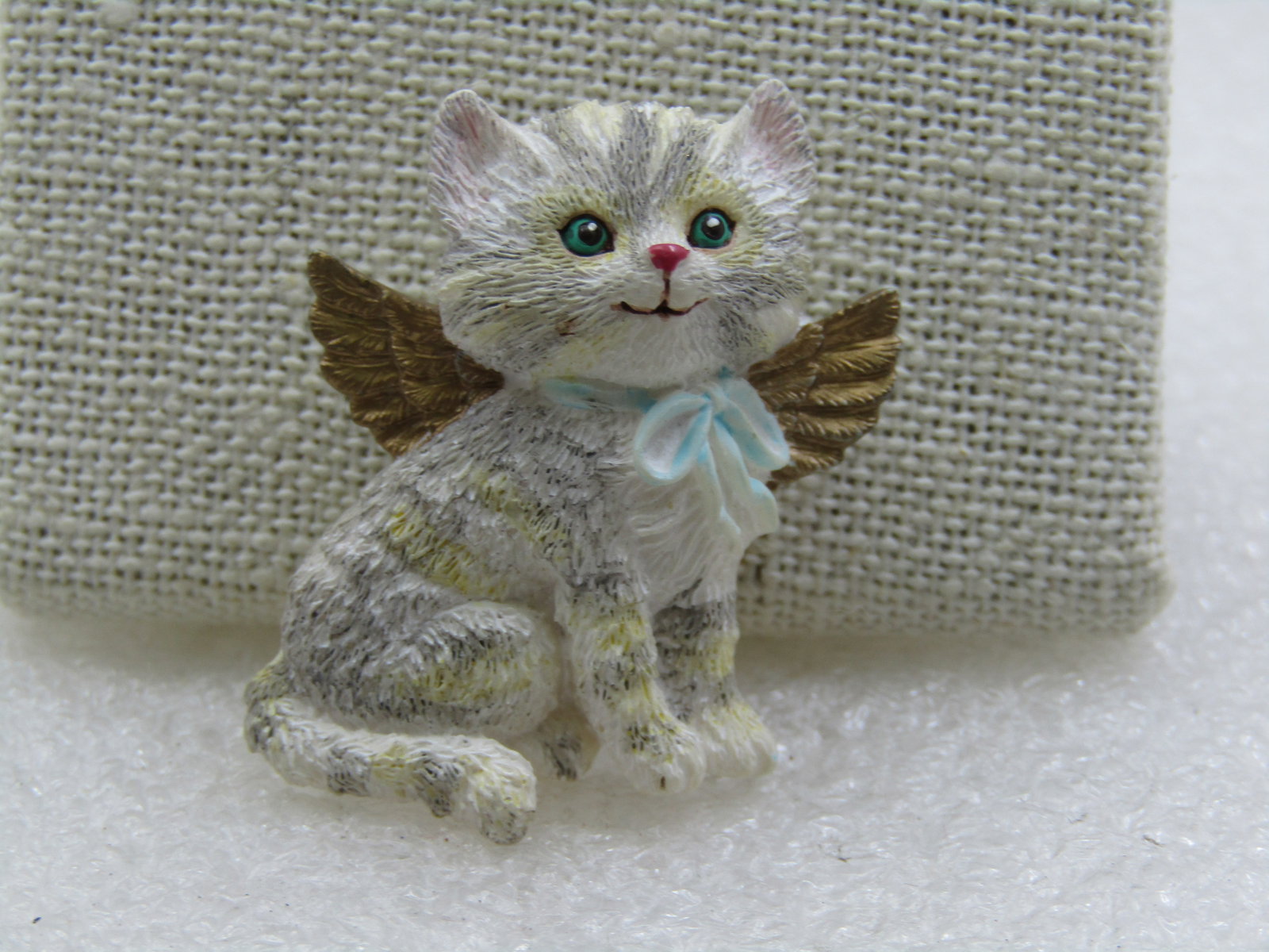 Vintage Angel Cat Brooch, Resin, 1.5", Gray and White: Vintage Angel Cat Brooch, Resin, 1.5", Gray and White. Gold wings, blue bow, green eyes with pink nose and mouth. This is a resin brooch popular in the 1980's with the angel theme and still around
