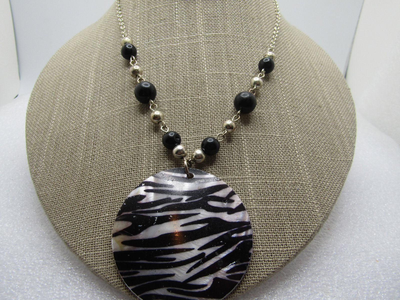 Vintage Zebra Print MOP Necklace, 21", 1980's: Vintage Zebra Print MOP Necklace, 21", 1980's. This has a domed mother-of-pearl 2" round pendant with zebra stripes painted on it and black and silver tone beads at the bottom part of the necklace. 