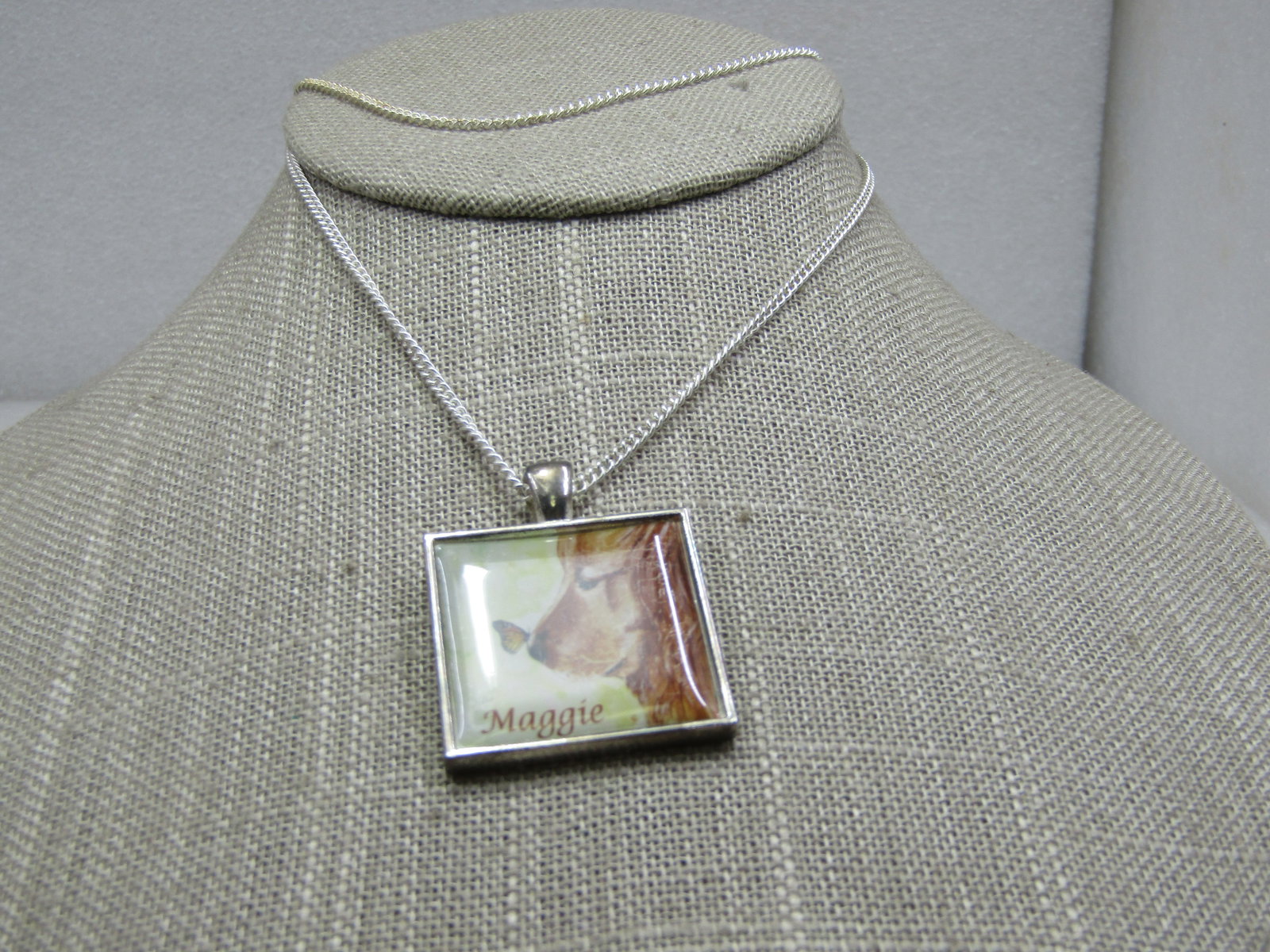 Maggie Gold Retriever Necklace, 20": Maggie Gold Retriever Necklace, 20". Butterfly on the nose, 1" square golden retriever with the name Maggie under clear plastic coating. Silver tone chain. Not marked or signed. Very good condition.