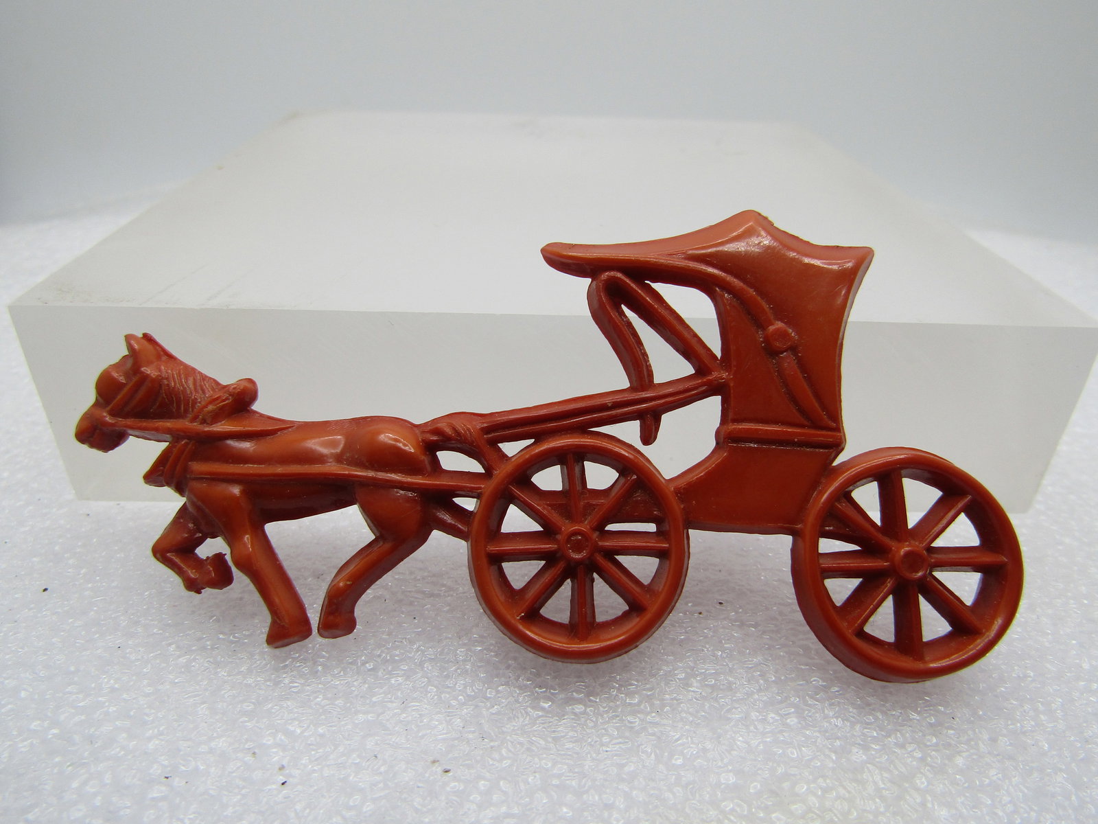 Vintage Brown Plastic Horse & Cart Brooch, 3.5", 1960's-1970's: Vintage Brown Plastic Horse & Cart Brooch, 3.5" by 1.75", 1960's-1970's The pin back is a plastic c-clasp built-in with a metal pin. It is not signed or marked. Very much like the Sunday Amish