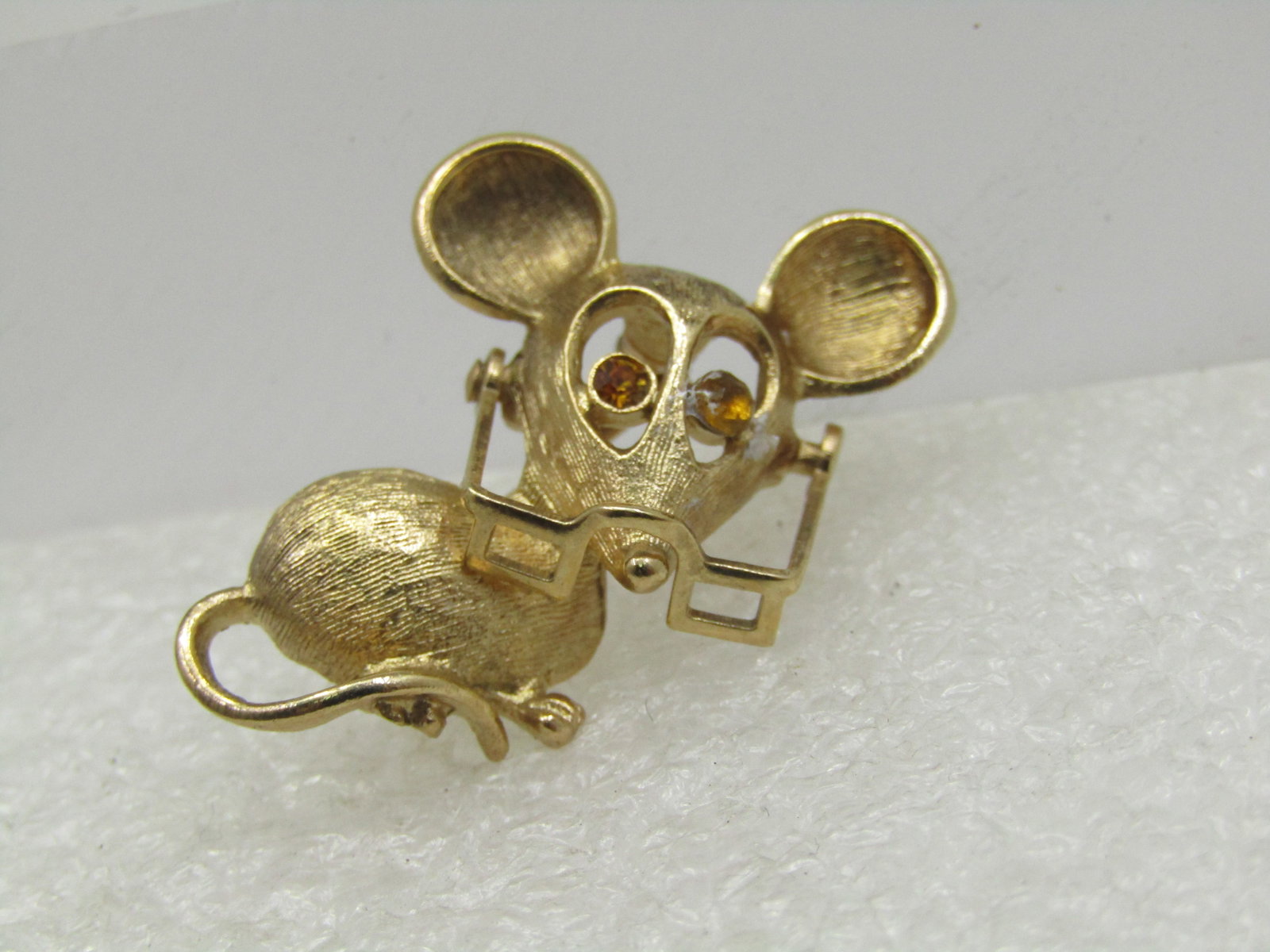 Vintage Mouse Wearing Movable Eyeglasses Brooch, Avon, 1960's-1970's: Vintage Mouse Wearing Movable Eyeglasses Brooch, Avon, 1960's-1970's. He has citrine colored rhinestone eyes with an opening area around the rhinestones and is glasses sit on his nose or move up to hi