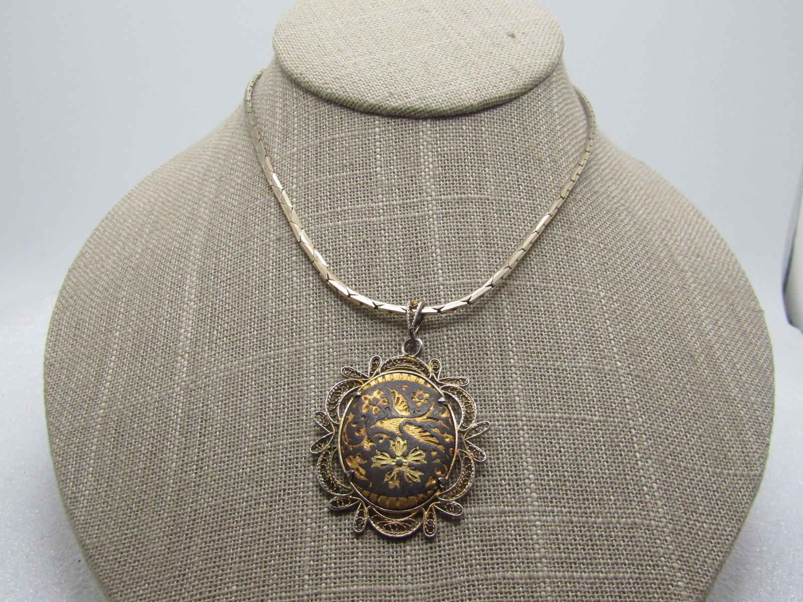 Vintage Damascene Necklace, 16", 1960's-1970's: Vintage Damascene Necklace, 16", 1960's-1970's. This has a fiigree framed damascene pendant with a bird and flowers. Gold tone and is appx. 2" tall with bail and 1.25" wide. the chain is an appx.