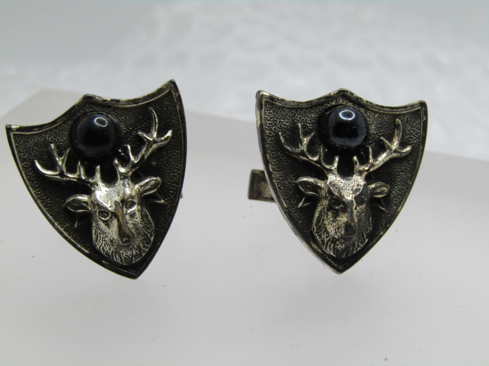 Vintage Buck/Elk Shield Cufflinks, Signed Kent, 1950's-1970's: Vintage Buck/Elk Shield Cufflinks, Signed Kent, 1950's-1970's. These are shield shapped and appx. 1" by 1" with a raised buck or elk on the front and a black 7mm round stone between the antlers. 