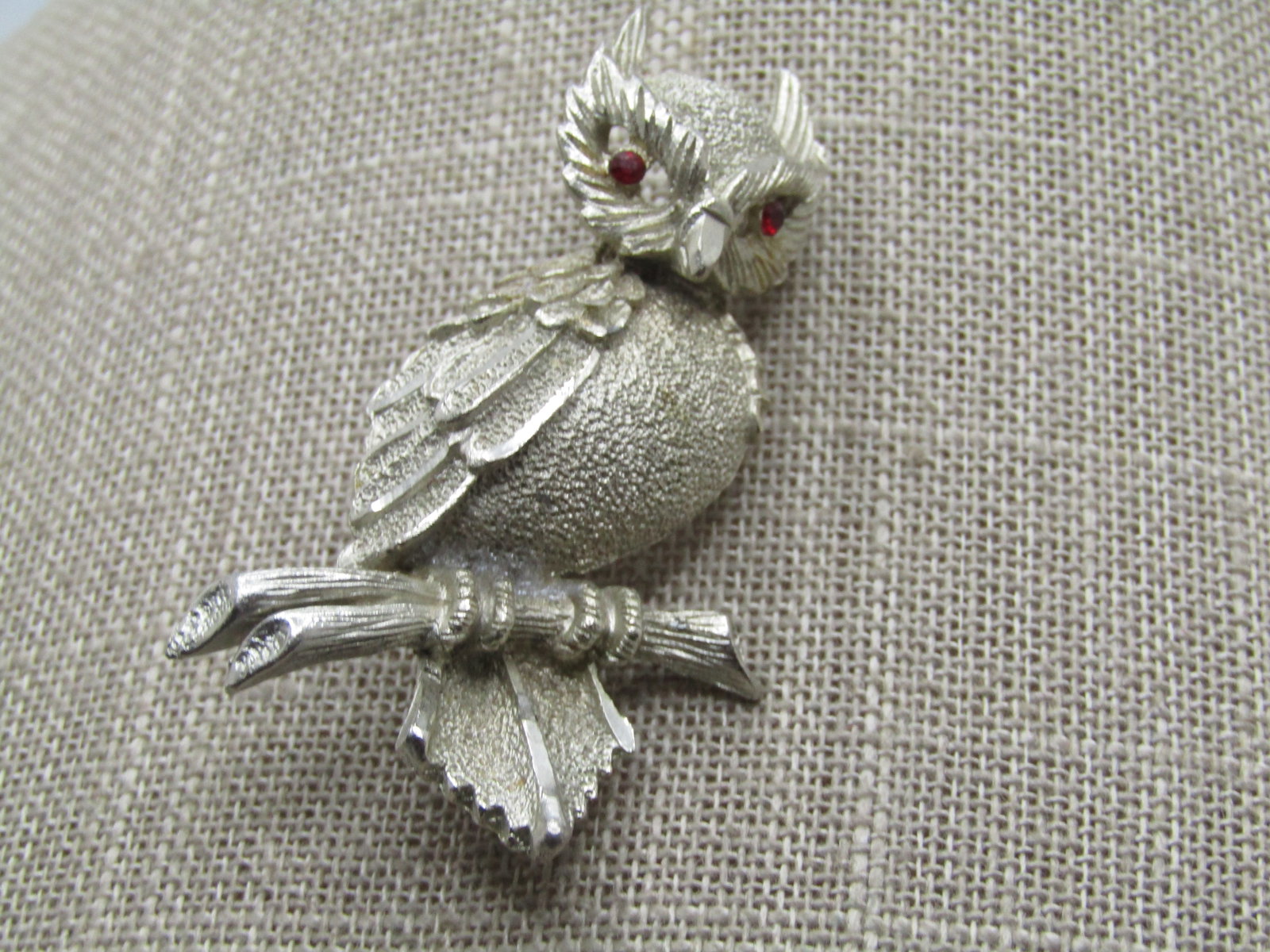 Vintage Owl Brooch, Rhinestone Eyes, BSK, 1960's-1970's: Vintage Owl Brooch, Rhinestone Eyes, BSK, 1960's-1970's. The owl has diamond cut accents ont he wing tips. It has open work around the eyes, he is sitting on a brach with textured and smooth detail. I