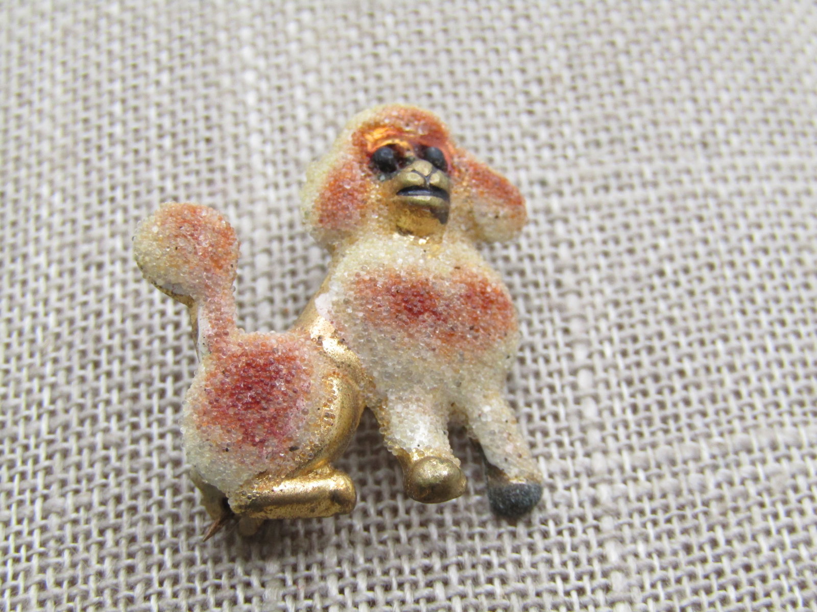 Vintage Sugary Poodle Brooch, 1950's-1960's, Gold Tone: Vintage Sugary Poodle Brooch, 1950's-1960's, Gold Tone. It is appx. 1" tall and 7/8" wide. This cute poodle has off white and coppery fur with a pom pom tail that is coated with a sugary clear