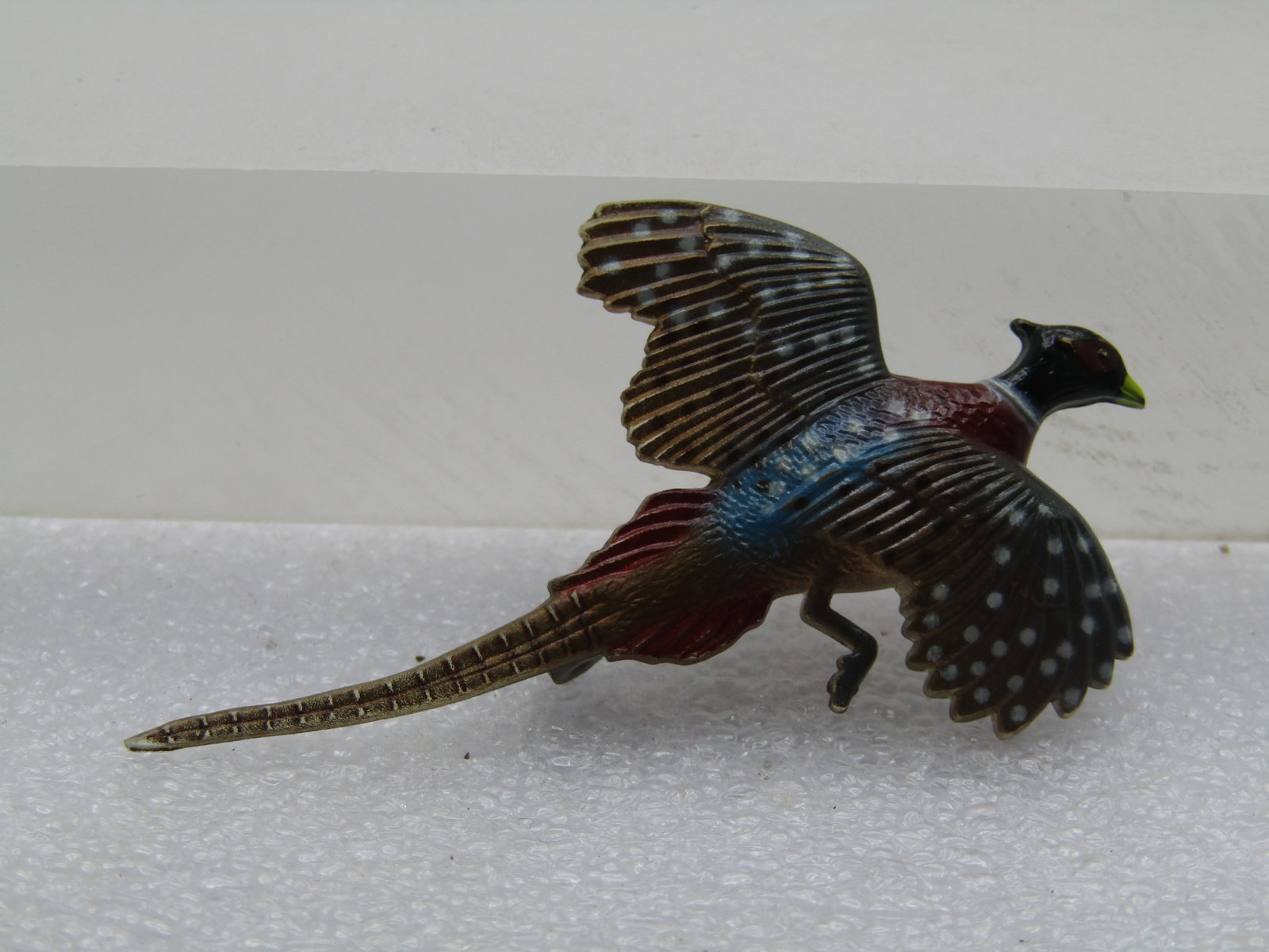 Vintage Detailed Pheasant Brooch, Painted, 1960's-1970's: Vintage Detailed Pheasant Brooch, Painted, 1960's-1970's. It has the look of carved and enameled painted but it is resin or plastic molded brooch with nice details of a pheasant in motion. It is