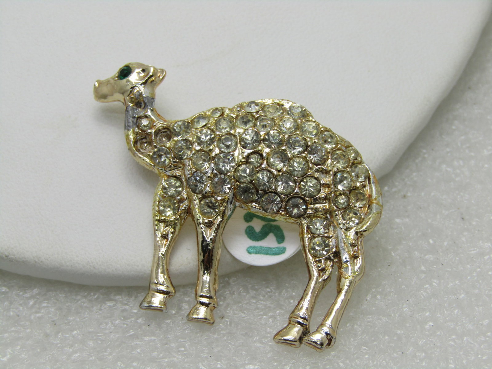 Vintage Gold Tone Rhinestone Camel Brooch, Gold Tone: Vintage Rhinestone Camel Brooch, 1-7/8" wide and 1.5" tall. This has pave-set rhinestones throughout the camel. The camel is domed with some shape, not flat. Green rhinestone eye. Circa 1960's. Gold t