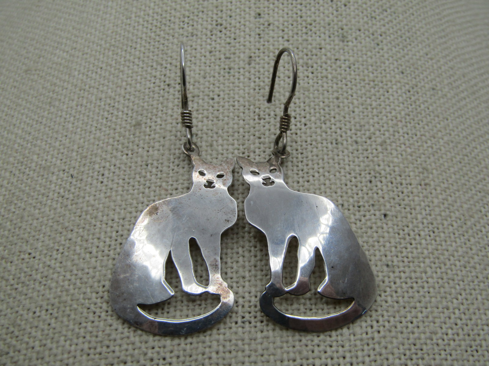 Vintage Sterling Hammered Cat Drop Earrings, Signed Wild Bryde, 1.75": Vintage Hammered Cat Drop Earrings, Signed Wild Bryde, 1.75" by 3/4" wide. Signed Sterling and Wild Bryde on the back. they have a smoother look, slightly domed on front and more hammered on the