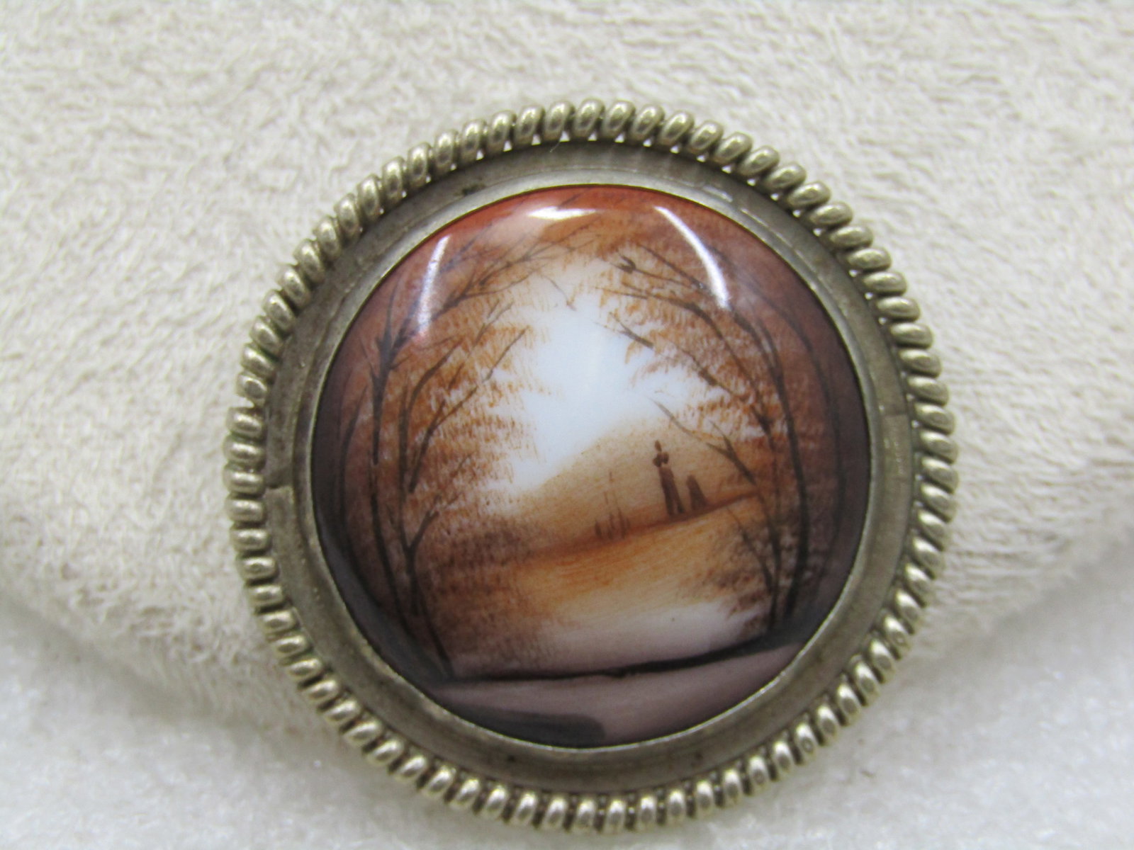 Vintage Painted Scenery Round Brooch, Silver Tone, C-Clasp: Vintage Painted Scenery Round Brooch, Silver Tone, C-Clasp - Fallish scene - out doors with a lane, trees and what looks like a man and a dog in the distance. Recessed edge and raped frame with a