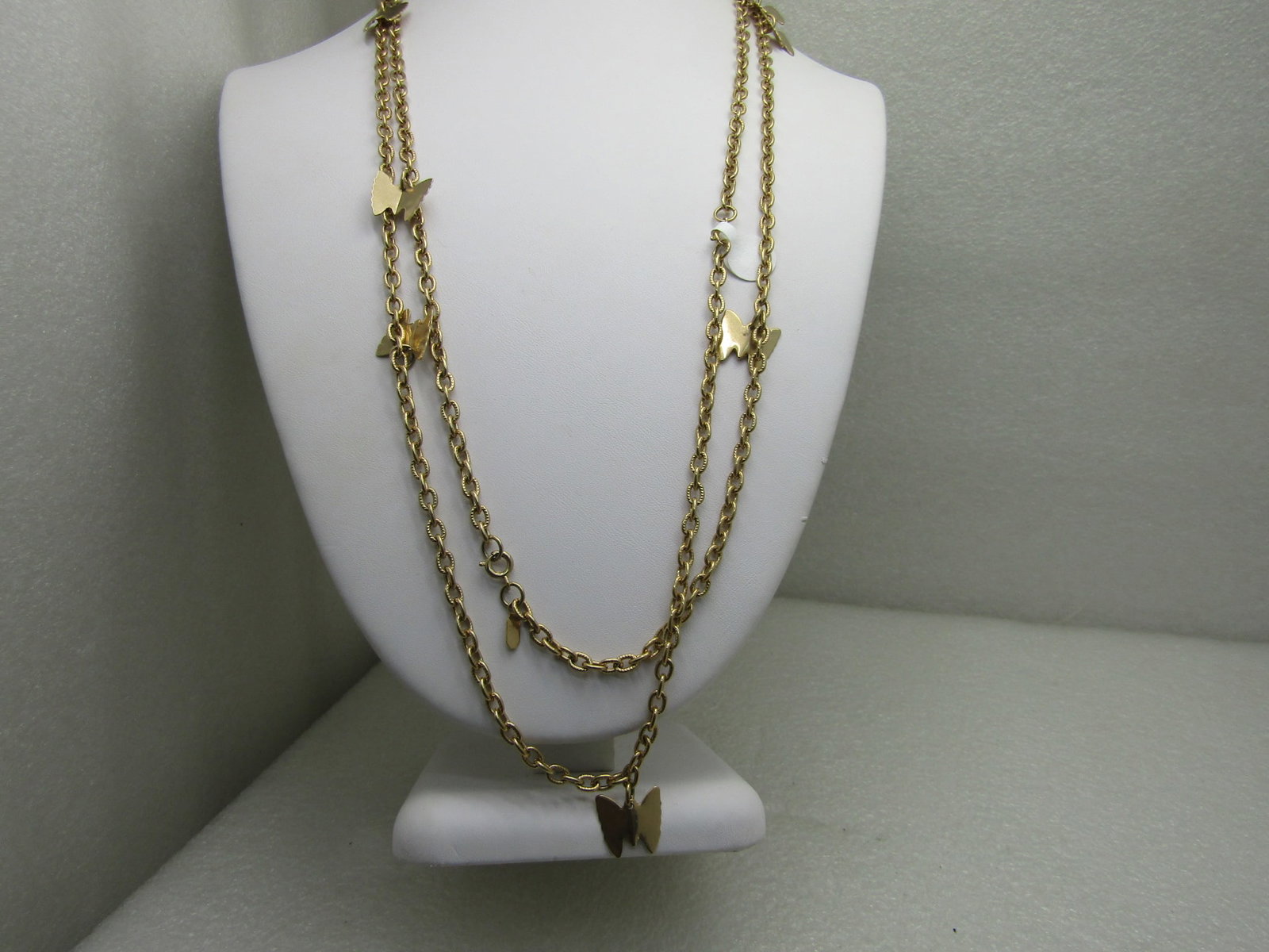 Vintage Sarah Coventry Gold Tone Butterfly Necklace 50": Vintage Sarah Coventry 50" Gold Tone Butterfly Necklace, can be doubled. Textured alternating oval links that are appx. 4.5mm wide. The necklace has ten 5/8" butterfly charms dangling from the chain.