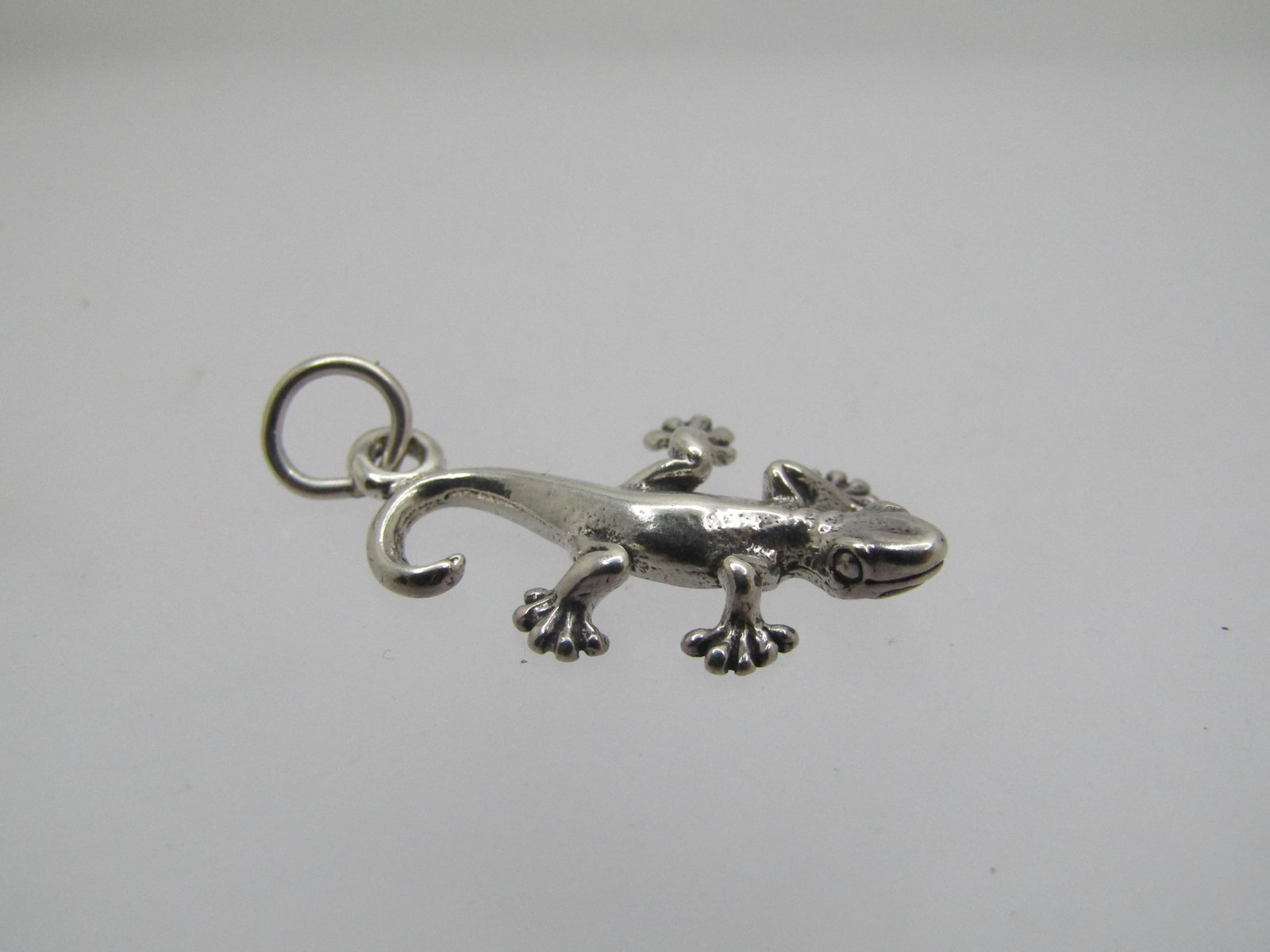 Vintage Sterling Gecko Charm/Pendant, 1" 1990's: Vintage Sterling Gecko Charm/Pendant, 1" 1990's. It is marked .925 and tests as sterling at 1.21 gr. It is appx. 1" long and appx. 5/8" wide at the back legs. Very good condition. Not signed by