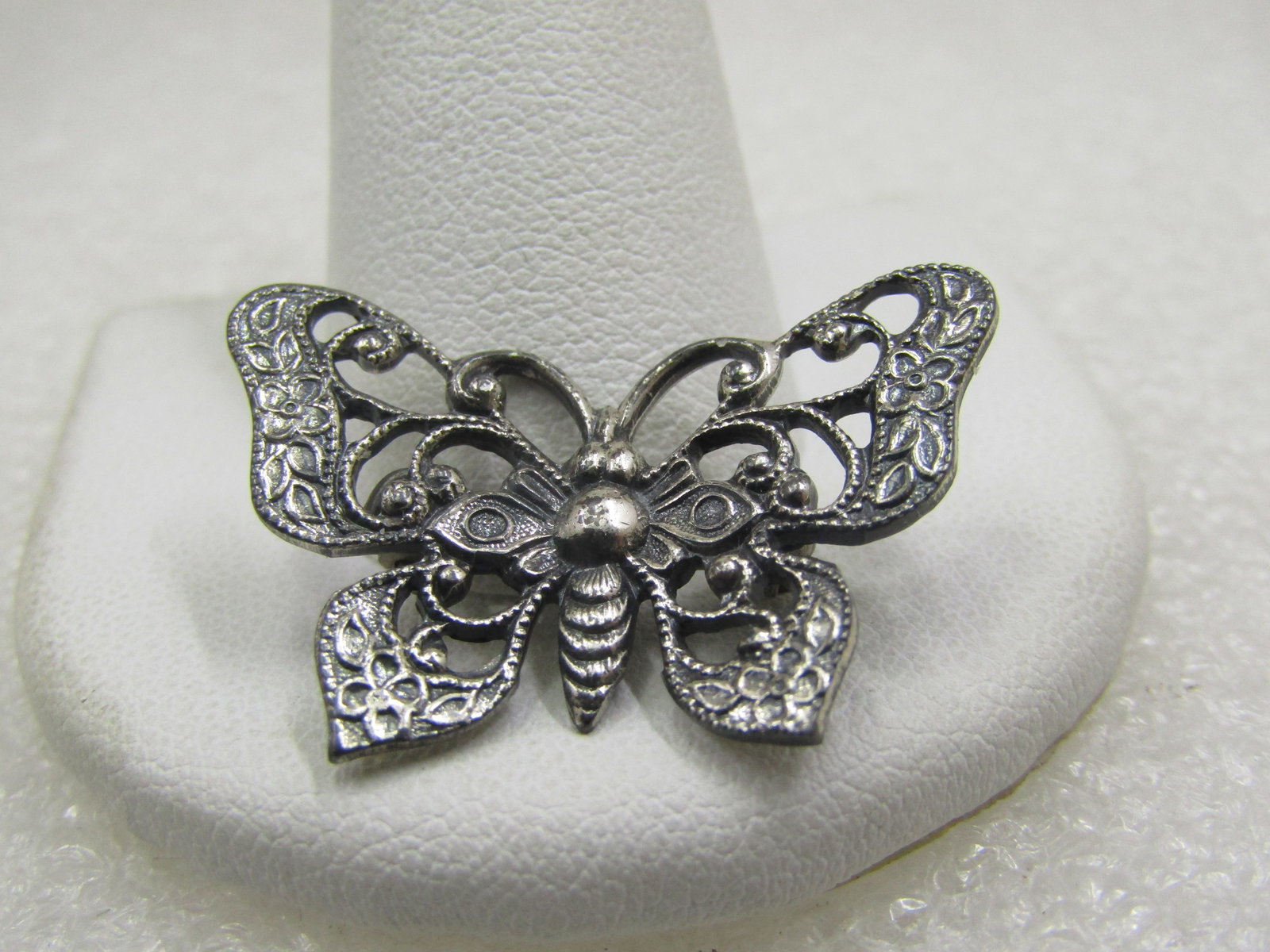Vintage Sterling Butterfly Brooch, Scrolled, 1-1/8": Vintage Sterling Butterfly Brooch, Scrolled, 1-1/8" wide and 3/4" tall. Filigree design with the look when first viewing that it could have marcasites stones, but it does not - simply a mix of smoth