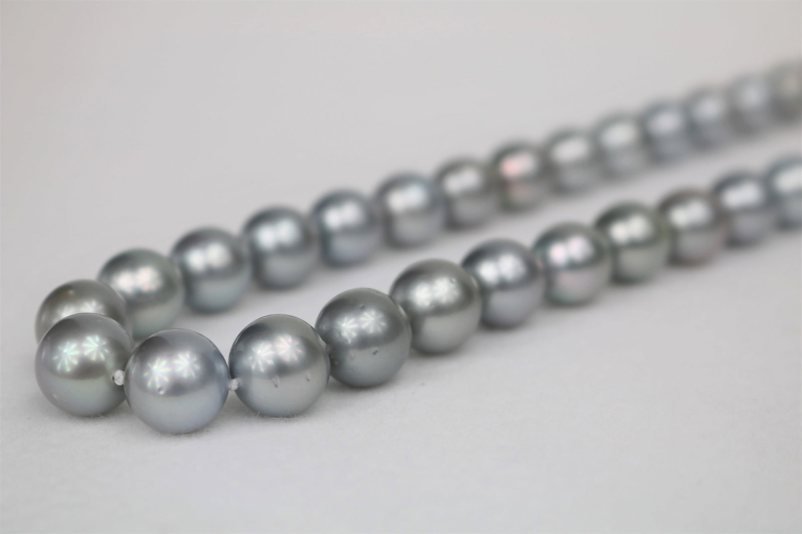 10-12mm Tahitain Platinum Silver Round Long Necklace with 14k Clasp: Title: 10-12mm Tahitain Platinum Silver Round Long Necklace with 14k ClaspDescription:AAA Luster, Tahitian Silver Platinum Necklace, 50 pearl pieces, 22 inches hand knotted with 14k white-gold