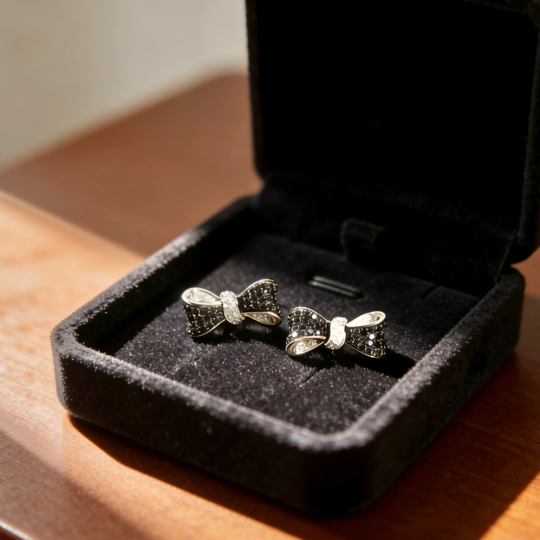 18K Gold Black Diamond Bow Earrings: Title: 18K Gold Black Diamond Bow Earrings Description: This earring is designed with a beloved butterfly element as inspiration, fully set with black diamonds, showcasing a cool style. The