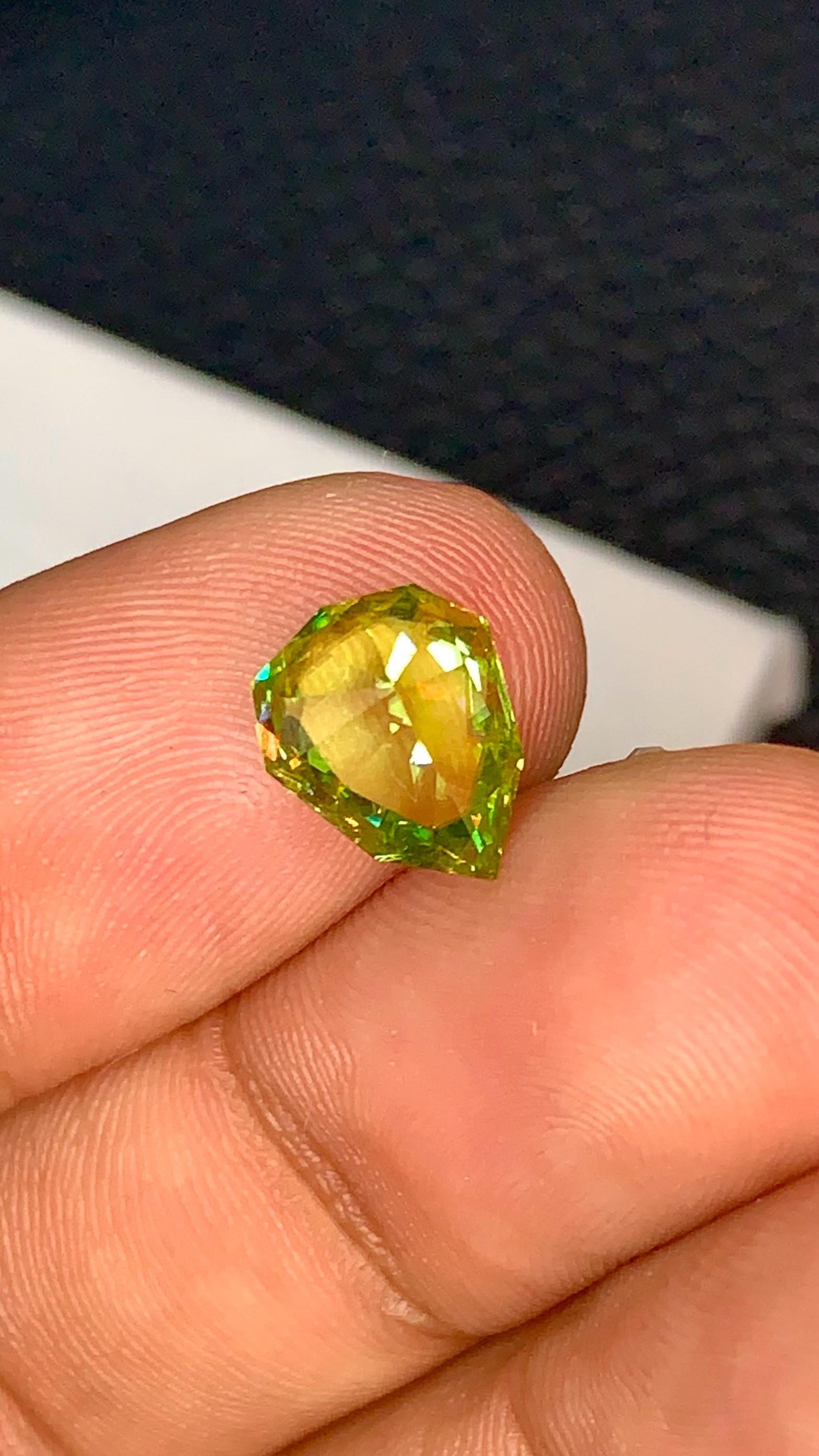 3.10 CT Sphene Titanite Gemstone: Faceted Sheild Cut, Eye Clean: Title:3.10 CT Sphene Titanite Gemstone: Faceted Sheild Cut, Eye Clean Description:Materials: Gemstone: Sphene Carat weight: 3.10 Discover the enchanting allure of our Sphene Titanite Loose Gemstone! T