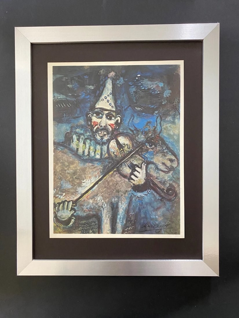 MARC CHAGALL | ORIGINAL VINTAGE 1975 PRINT | SIGNED | MOUNTED AND FRAMED: Beautiful and Scarce Original 1975 Print After Marc Chagall "The Clown Musician" Facsimile Signature in Ink Published by Verlag Schauberg in Koln, West Germany Art Print is about 11 1/2 X 9 in. This