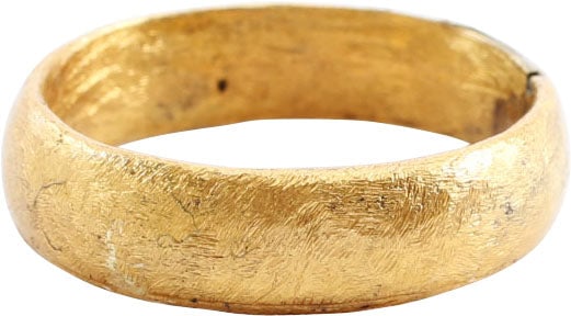 VIKING WOMAN’S WEDDING RING, 9TH-11TH CENTURY AD, SIZE 7 3/4: Cambridgeshire, England, 9th-11th century AD. Gilt bronze, size 7 3/4. 5.4mm width band with well rounded face. Made with a core filling the inside which distributed the flowing metal and allowed for 