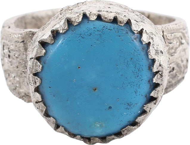 EASTERN EUROPEAN GYPSY RING SIZE 9 3/4: White metal, "base silver". Stirrup form, size 9 3/4-10. Large oval bezel with toothed base and raised central blue "stone". Worn from use. Good quality for these with a balance of Gypsy flare and Eur