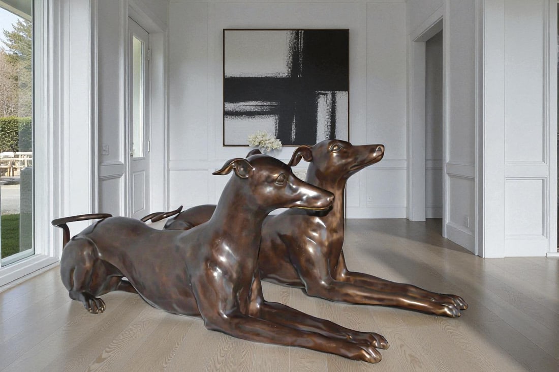 Pair of Greyhound dogs laying down Bronze Statues - Size: 50"L x 11"W x 20"H. - 2