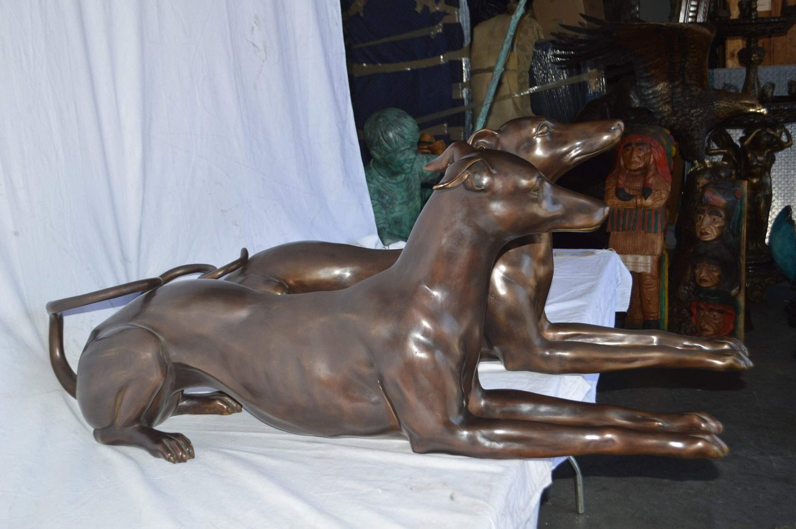 Pair of Greyhound dogs laying down Bronze Statues - Size: 50"L x 11"W x 20"H. - 4