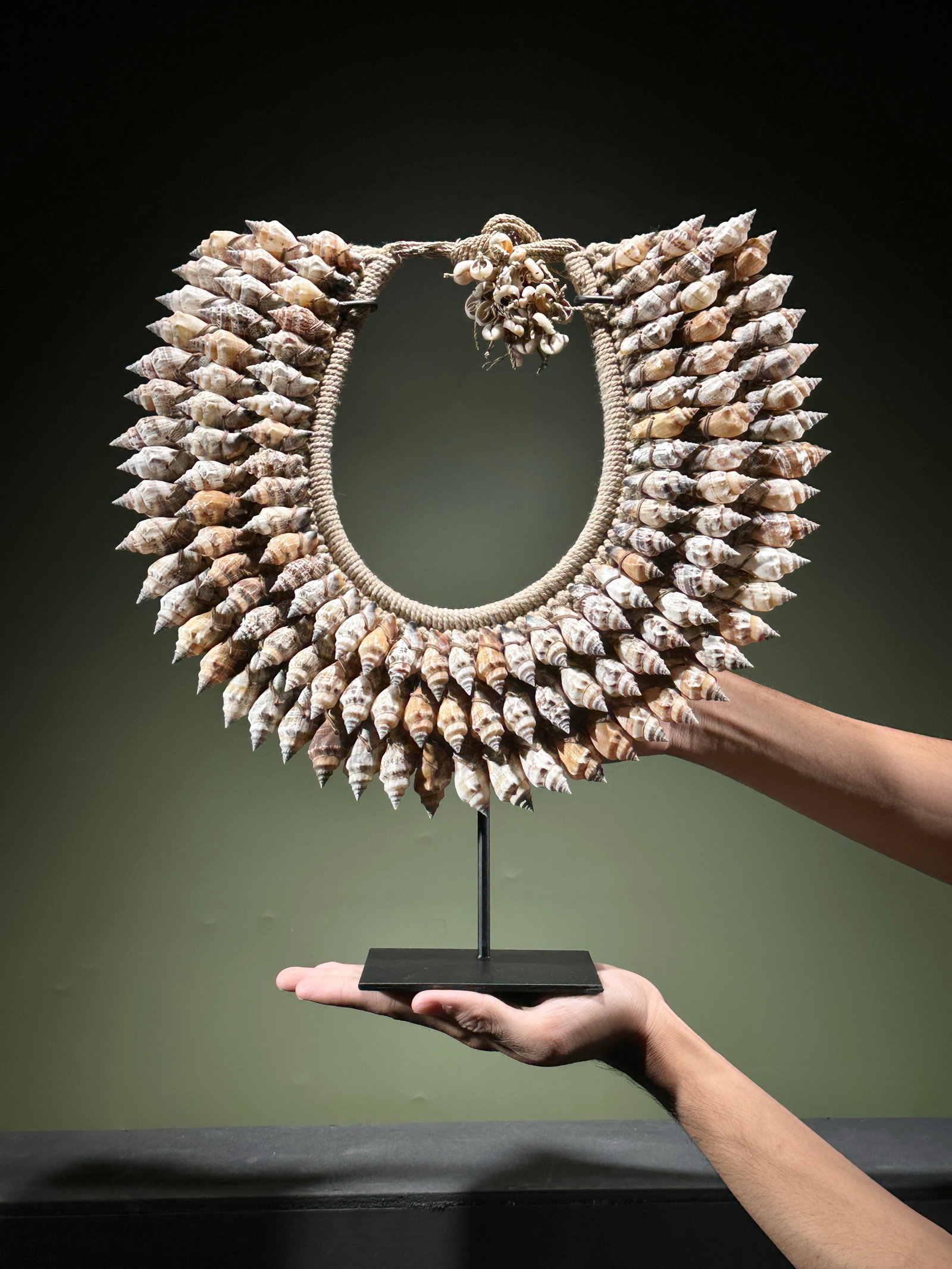 Decorative shell necklace on a custom stand: Title:Decorative shell necklace on a custom stand,li>Maker:UnknownOrigin:IndonesiaDate/Period:2026Materials:Shells, natural fibers, steelDimensions:Height including stand: 39 cm / 15.3 inches Width: