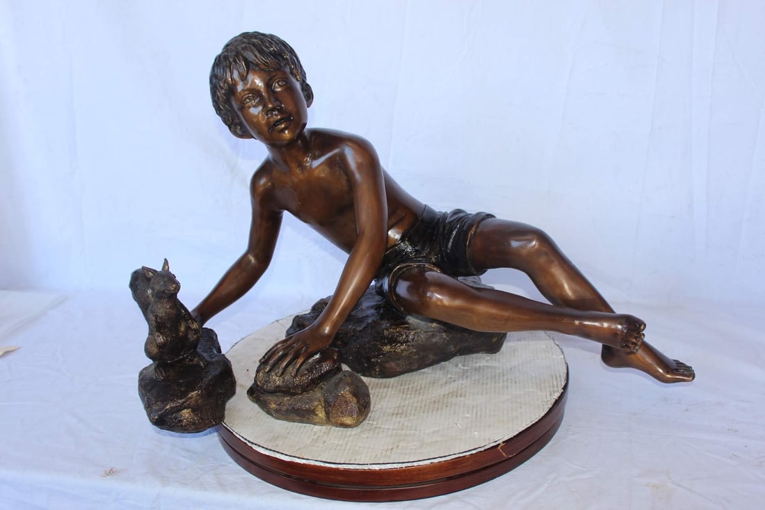 Adventurous boy with squirrel bronze statue - Size: 36"L x 18"W x 22"H. - 4