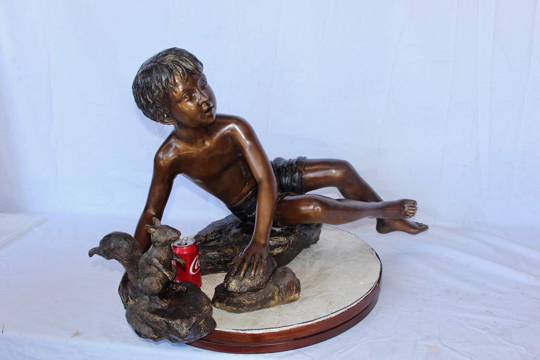 Adventurous boy with squirrel bronze statue - Size: 36"L x 18"W x 22"H. - 5