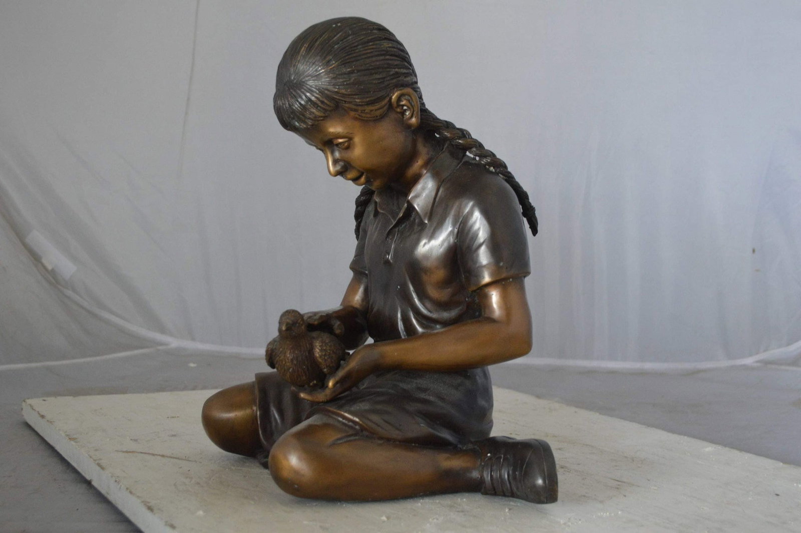 Young seated girl with bird bronze statue - Size: 12"L x 9"W x 14"H. - 7
