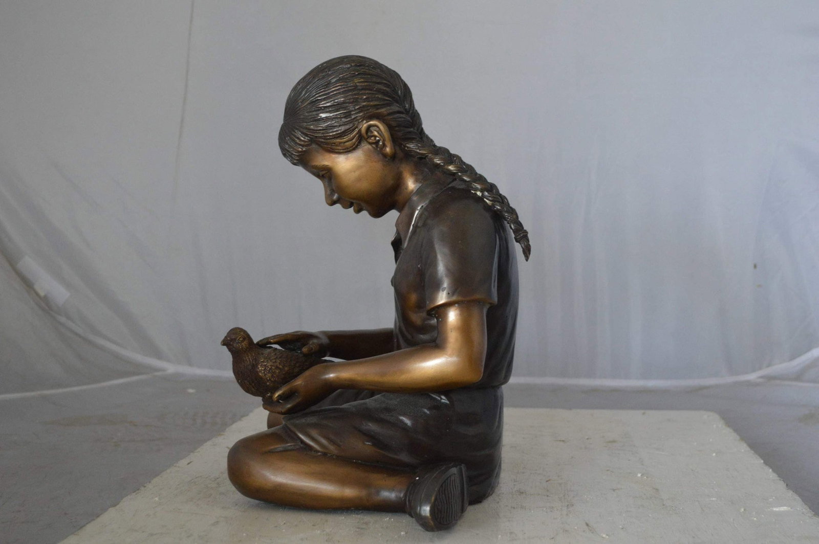 Young seated girl with bird bronze statue - Size: 12"L x 9"W x 14"H. - 8