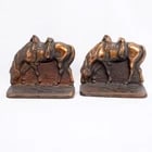 Pair Iron Riderless Iron Horse Bookends: Title:Pair Iron Riderless Iron Horse BookendsSize:5 ? in (13.3 cm) long x 2 in (5.1 cm) deep x 4 ? in (12.1 cm) tall.Description:These evocative cast iron bookends capture a moment of quiet