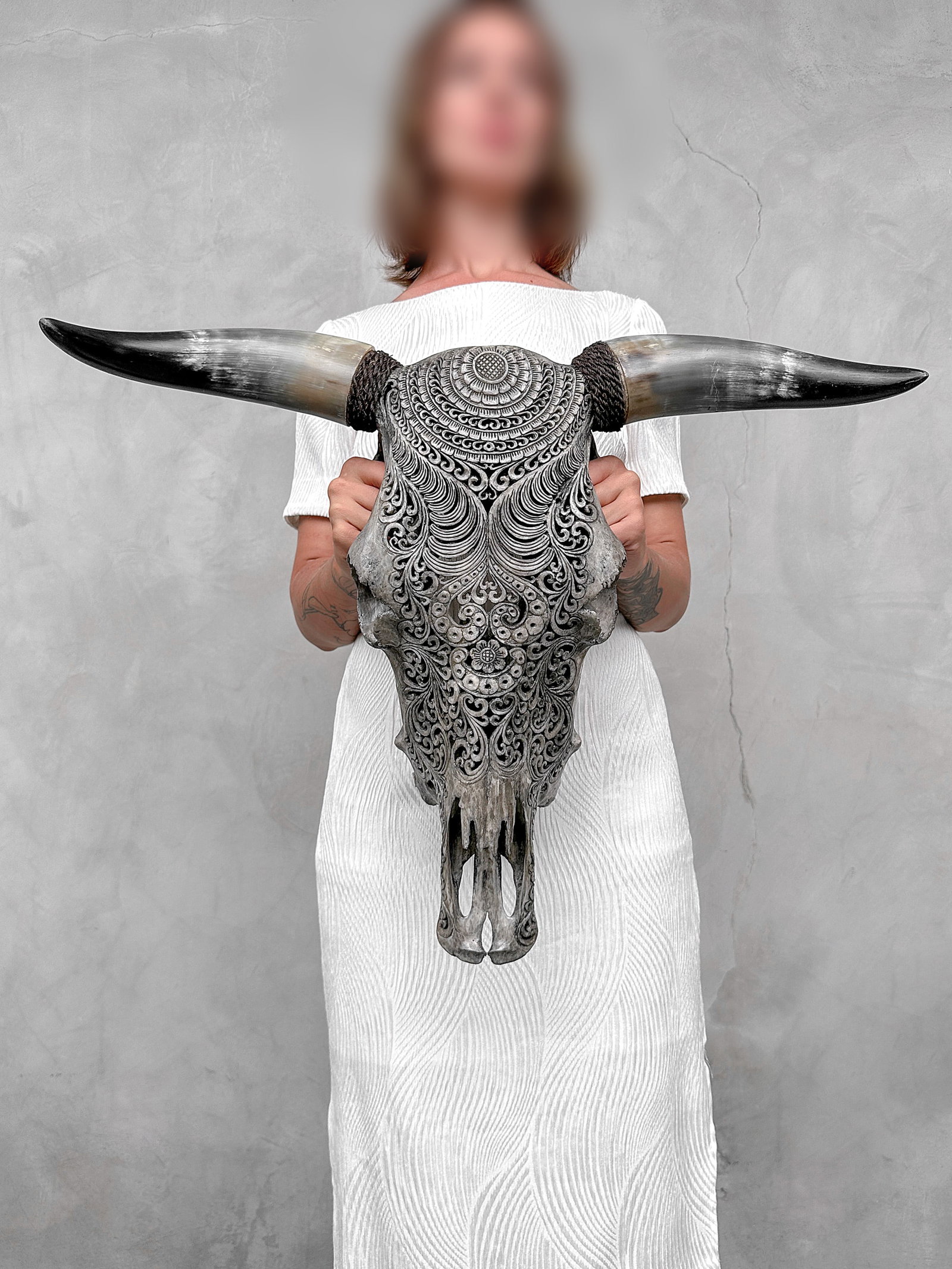 Stunning carved grey bull's skull - Badong motif: Title:Stunning carved grey bull's skull - Badong motif,li>Maker:UnknownOrigin:IndonesiaDate/Period:2026Materials:Bos Taurus, Bone, HornDimensions:Height: 50 cm / 19.6 inches Width: 62 cm / 24.4