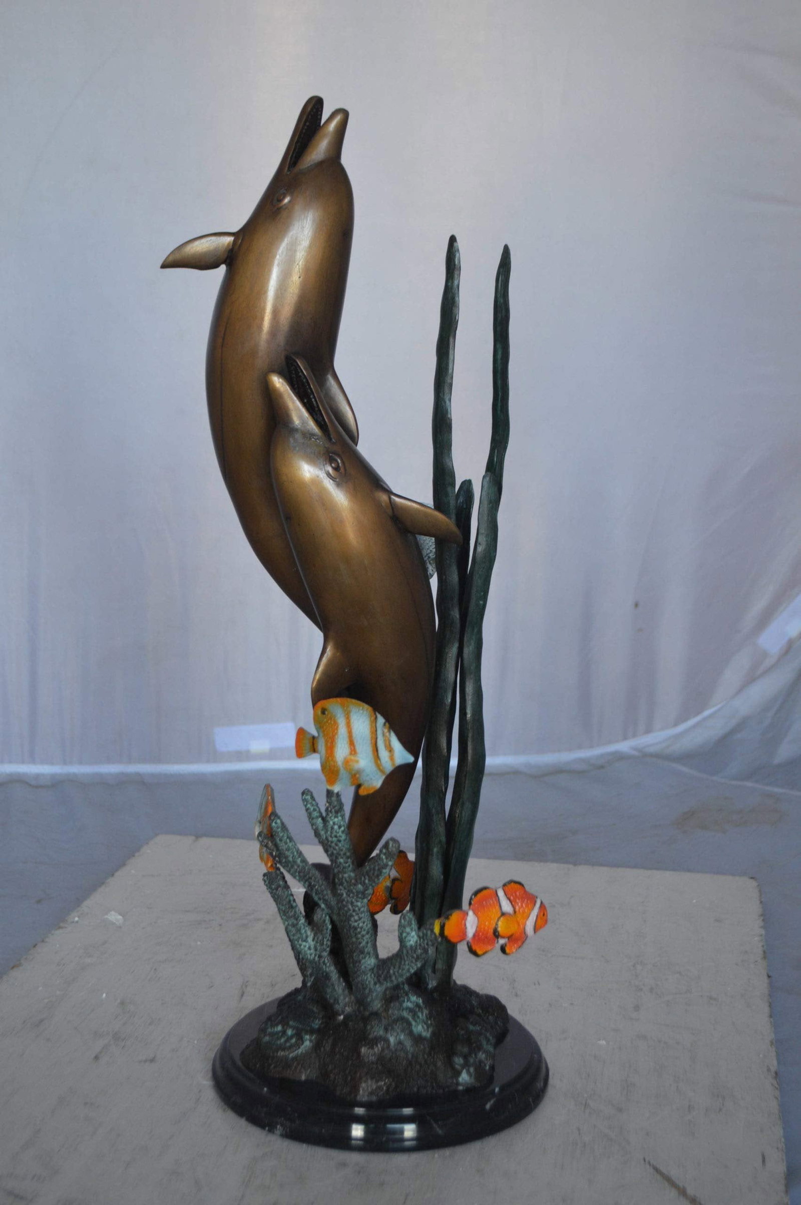 Two dolphins with fish, table top bronze statue. - Size: 8"L x 8"W x 22"H. - 9