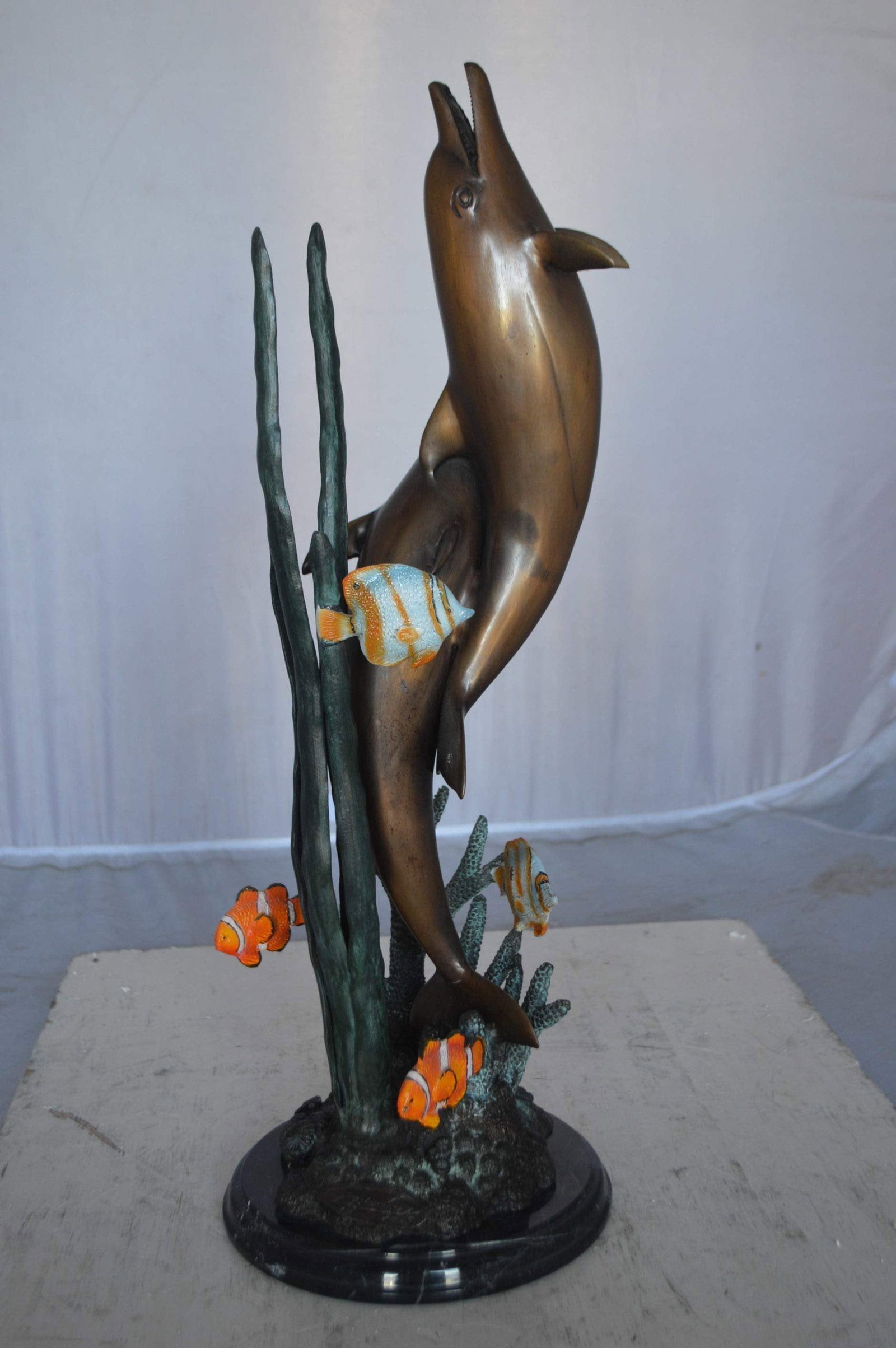 Two dolphins with fish, table top bronze statue. - Size: 8"L x 8"W x 22"H. - 4