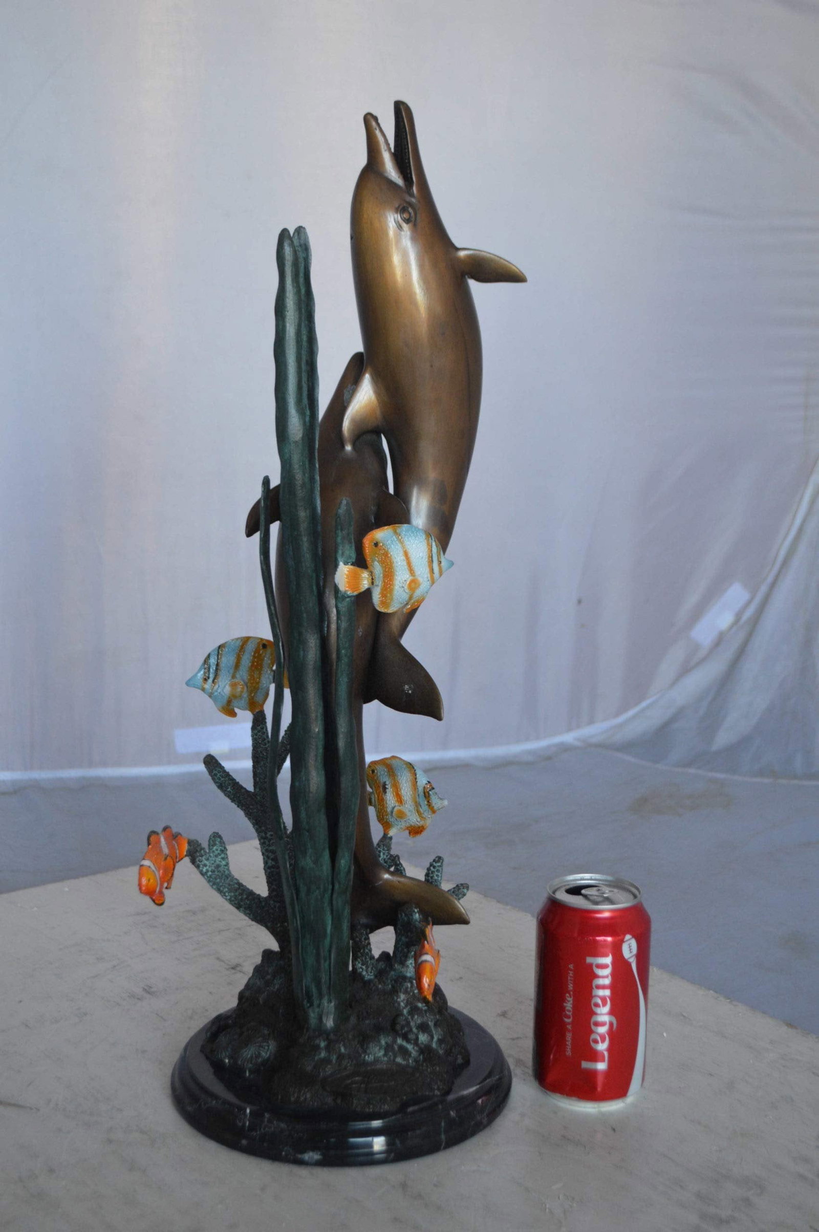 Two dolphins with fish, table top bronze statue. - Size: 8"L x 8"W x 22"H. - 6