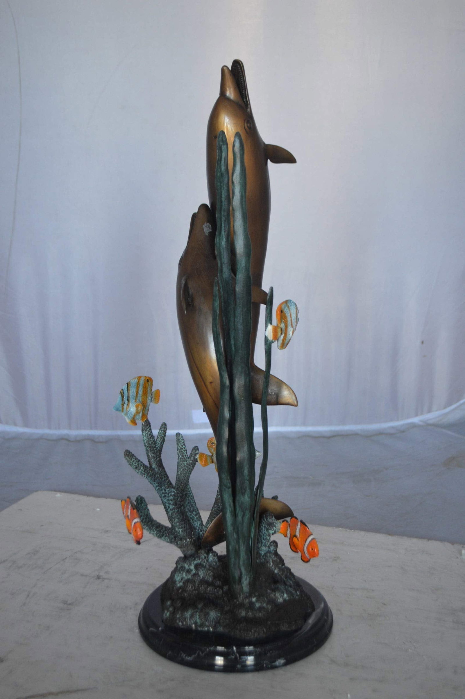 Two dolphins with fish, table top bronze statue. - Size: 8"L x 8"W x 22"H. - 7