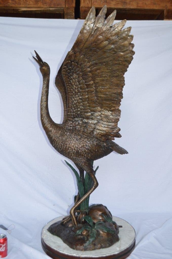 Crane standing on a stone bronze statue - Size: 28"L x 32"W x 49"H. - 10