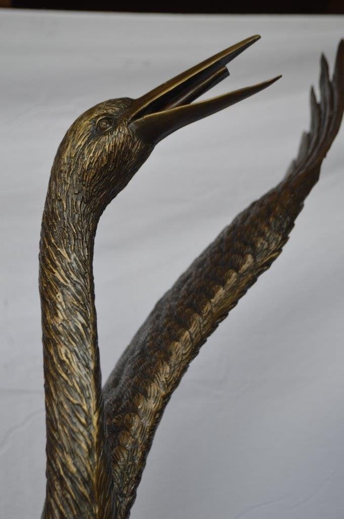 Crane standing on a stone bronze statue - Size: 28"L x 32"W x 49"H. - 3