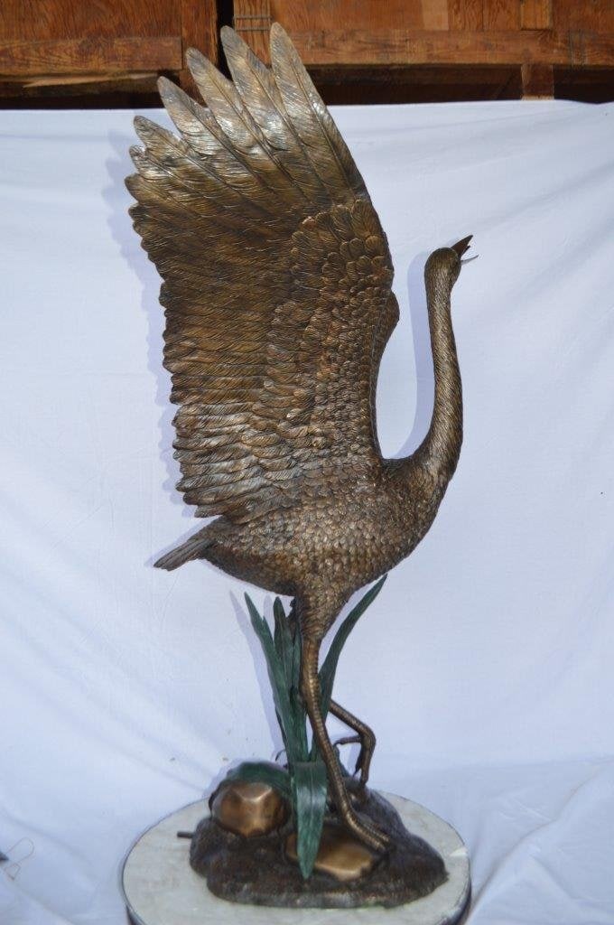 Crane standing on a stone bronze statue - Size: 28"L x 32"W x 49"H. - 5