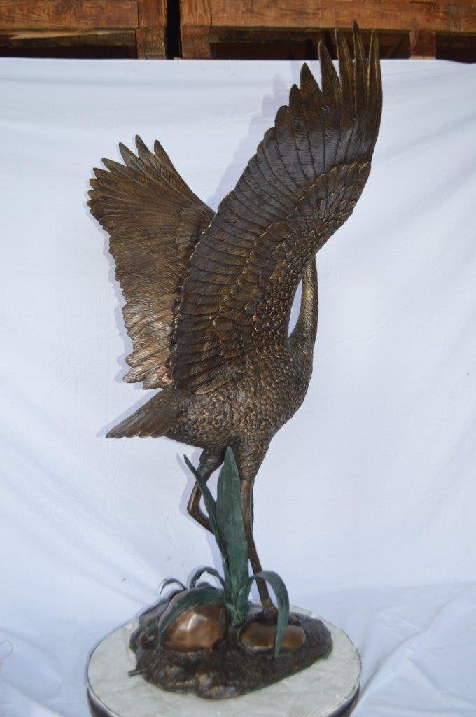 Crane standing on a stone bronze statue - Size: 28"L x 32"W x 49"H. - 6