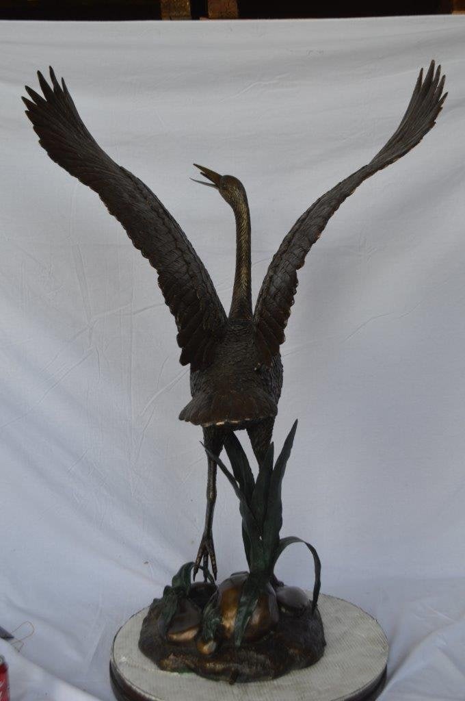Crane standing on a stone bronze statue - Size: 28"L x 32"W x 49"H. - 8