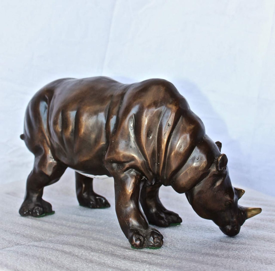 Relaxed Rhino bronze statue - Size: 16"L x 9"W x 8"H. - 8