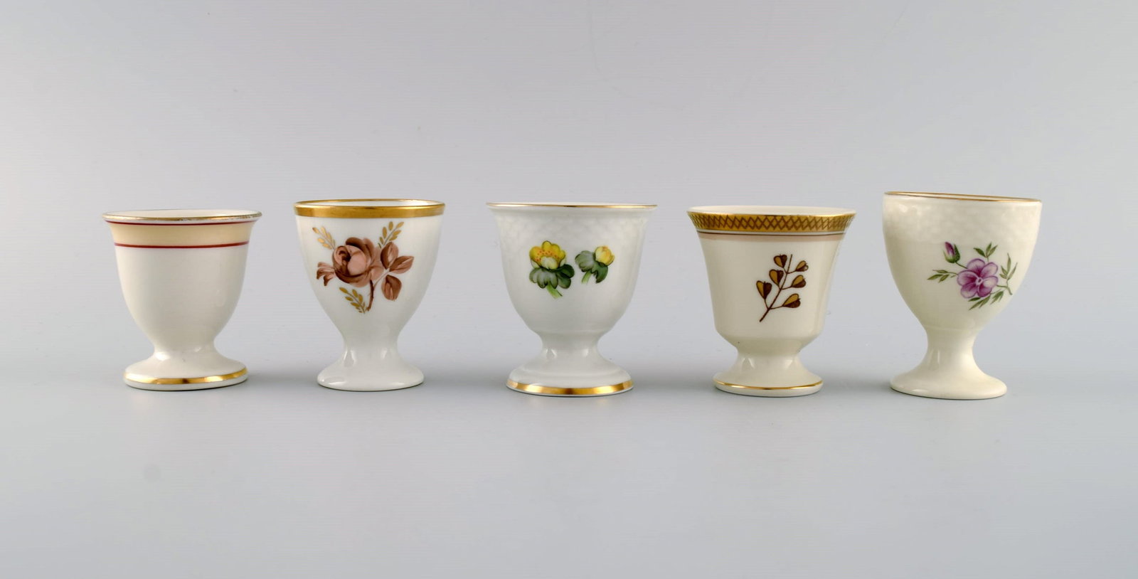 Royal Copenhagen and Bing & Grøndahl. Five egg cups in hand-painted porcelain. 1920s / 30s.: Title: Royal Copenhagen and Bing & Grøndahl. Five egg cups in hand-painted porcelain. 1920s / 30s. Description: Royal Copenhagen and Bing & Grøndahl. Five egg cups in hand-painted porcelain.