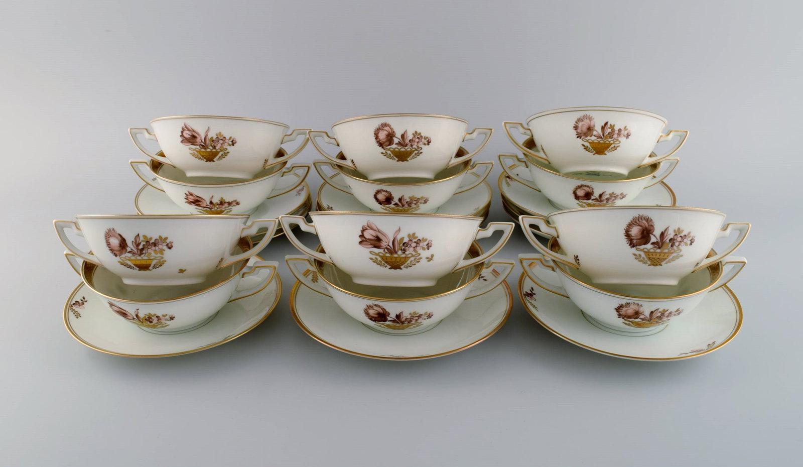 Twelve Royal Copenhagen Golden Basket bouillon cups with saucers.: Title: Twelve Royal Copenhagen Golden Basket bouillon cups with saucers. Description: Twelve Royal Copenhagen Golden Basket bouillon cups with saucers. Model number 595/9571. Dated 1889-1922. The cup
