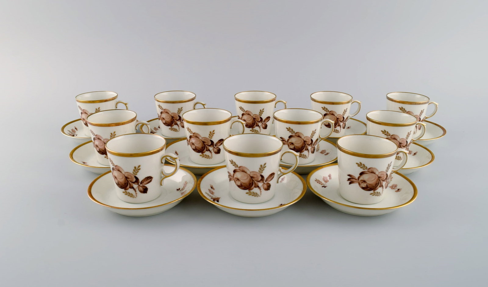 12 Royal Copenhagen Brown Rose mocha / coffee cups with saucers in hand-painted porcelain with: Title: 12 Royal Copenhagen Brown Rose mocha / coffee cups with saucers in hand-painted porcelain with flowers and gold edge. Dated 1968. Description: 12 Royal Copenhagen Brown Rose mocha / coffee cups
