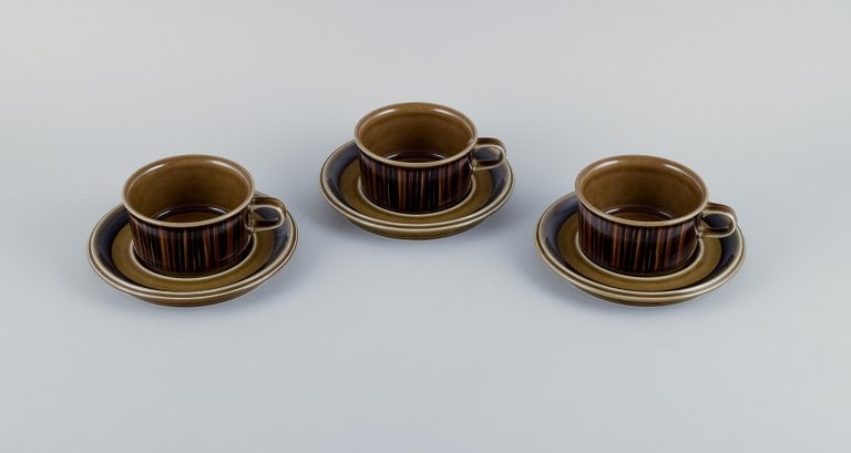 Gunvor Olin-Grönqvist for Arabia, "Cosmos," three sets of tea cups with saucers. Stoneware in a: Title: Gunvor Olin-Grönqvist for Arabia, "Cosmos," three sets of tea cups with saucers. Stoneware in a retro style. Glazed in green-brown tones. Description: Gunvor Olin-Grönqvist for Arabia